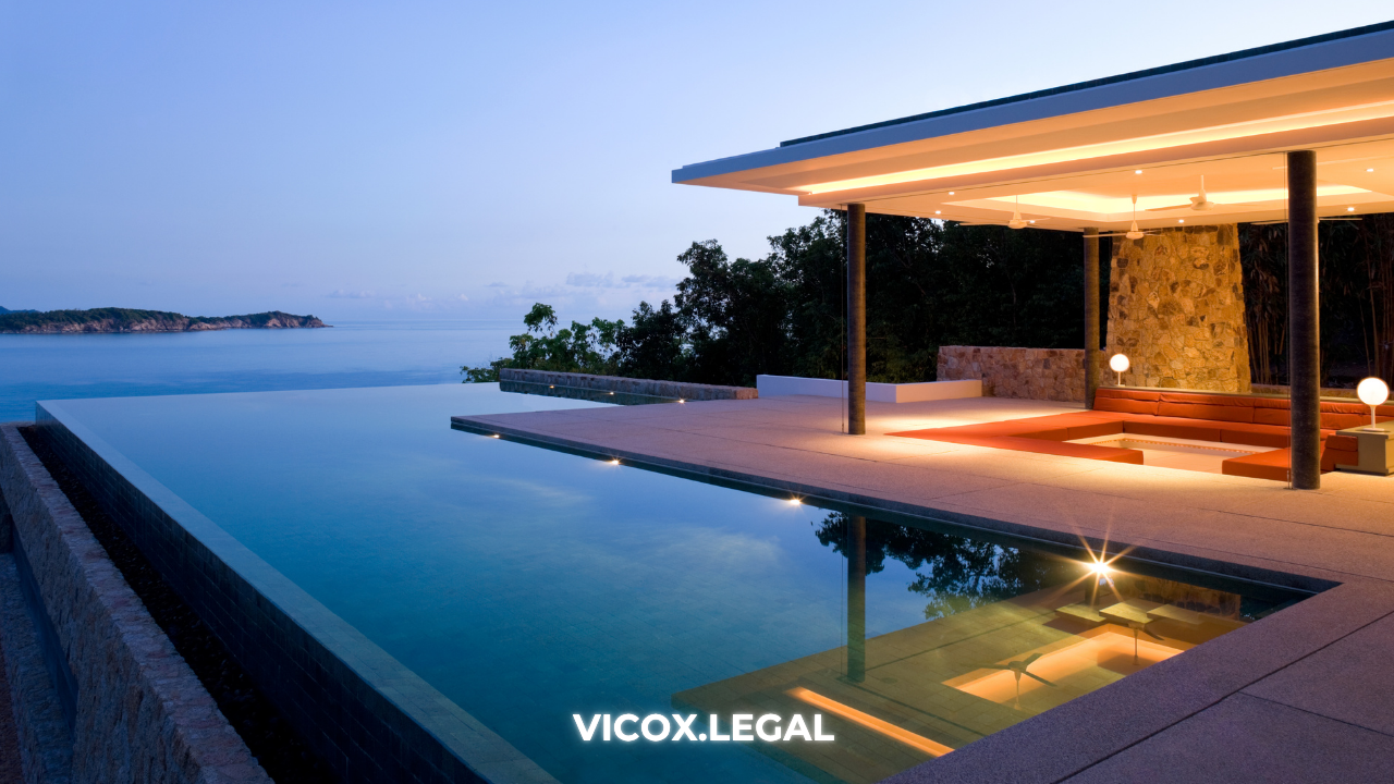 Modern villa with infinity pool overlooking the sea at sunset, representing high-end real estate in Spain bought with cryptocurrency.