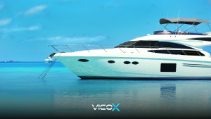 A luxury superyacht anchored in the Spanish Mediterranean at sunset, featuring a tablet displaying a secure Bitcoin transaction on deck. Represents buying luxury assets with cryptocurrency.